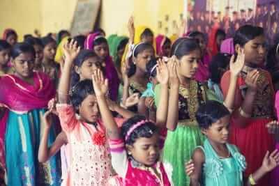 Good News India children praying and singing. Good News India children praying and singing.